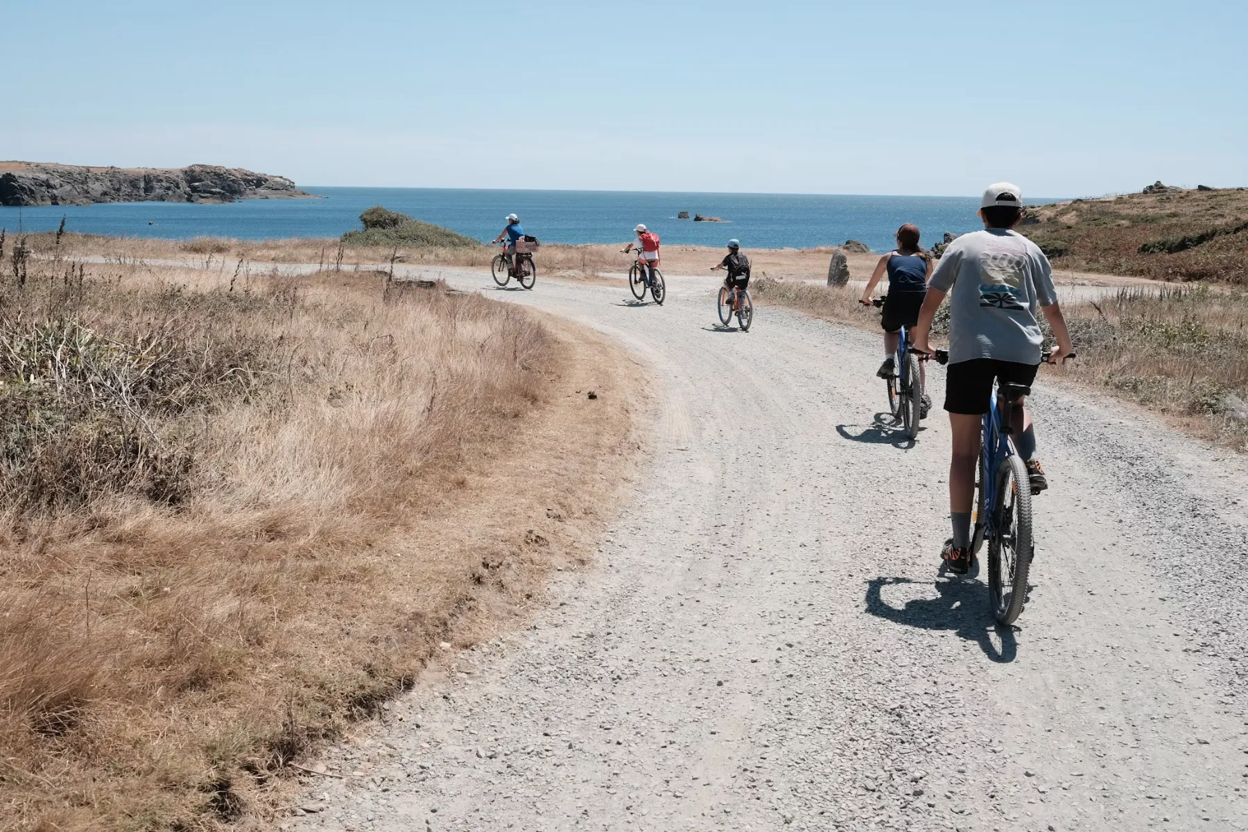 A group cycling a coastal gravel track